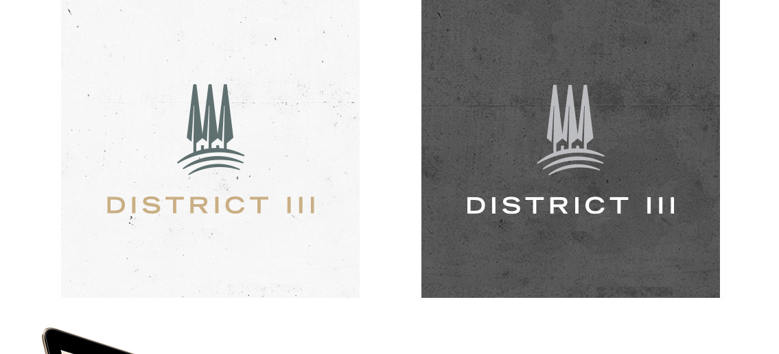 Close-up of District III logos, featuring the silhouettes of trees.